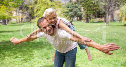 Adorable little girl having fun with her father