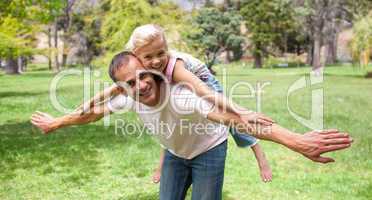 Adorable little girl having fun with her father