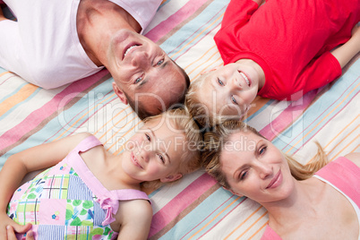 Jolly family sleeping lying on the grass