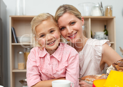 Jolly little girl eating fruit with her mother