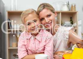 Jolly little girl eating fruit with her mother