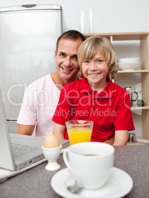 Happy father and his son having breakfast