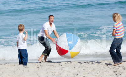 Happy father and his children playing with a ball