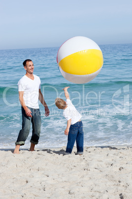 Happy father and his son playing with a ball