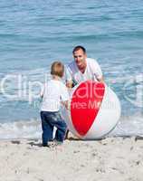 Jolly father and his son playing with a ball
