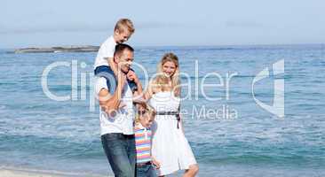 Lively family walking on the sand