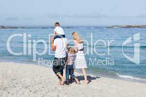 Affectionate family walking on the sand