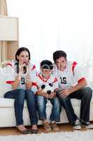 Concentrated family watching football match