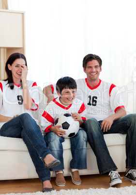 Positive family watching football match