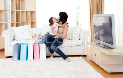 Happy mother and her daughter at home after shopping