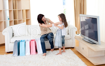 Joyful mother and her daughter at home after shopping