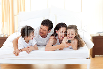Happy family having fun in the bedroom