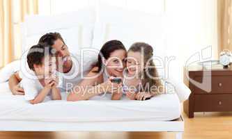 Joyful family having fun in the bedroom