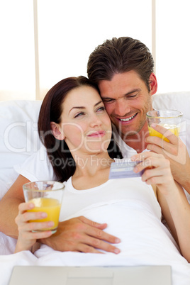 Intimate couple drinking orange juice