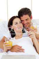 Intimate couple drinking orange juice