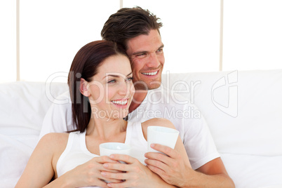 Smiling couple drinking coffee