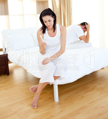 Cheerless couple finding out results of a pregnancy test