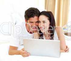 Affectionate couple using laptop