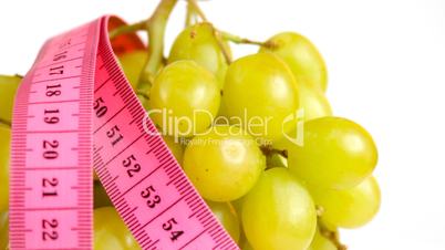 Tape measure wrapped around rotating grapes, loopable