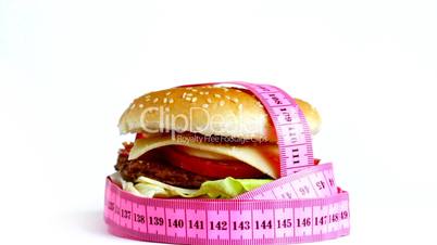 Tape measure wrapped around rotating hamburger,