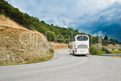 The modern tourist bus on mountain road