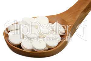 Tablets in a wooden spoon