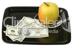 US dollars and yellow apple