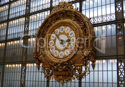 Golden clock on the wall of d'Orsay museum in Paris