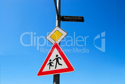 Priority road and children crossing road signs