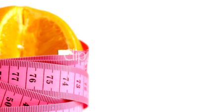 Tape measure wrapped around rotating orange, loopable
