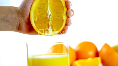 Squeezing orange juice into glass