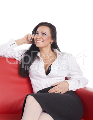 sexual woman call phone and smile on red sofa