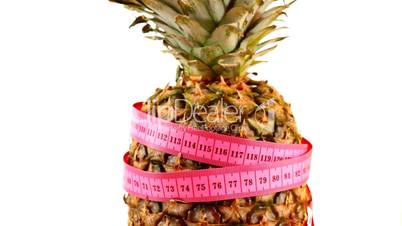 Tape measure wrapped around rotating pineapple, loopable