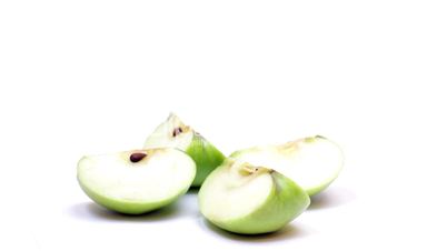 Rotating pieces of green apple , loopable