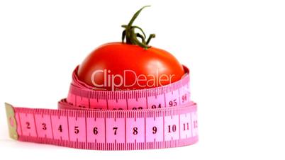 Tape measure wrapped around rotating tomato, loopable