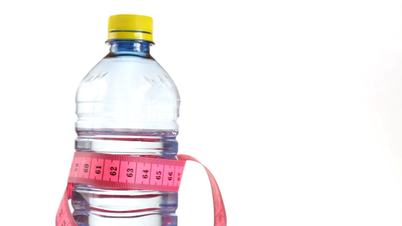 Tape measure wrapped around bottle of water, loopable
