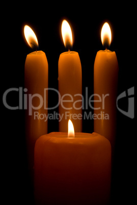 Burning candles over a black background