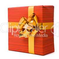 Red gift box with golden bow on a white background