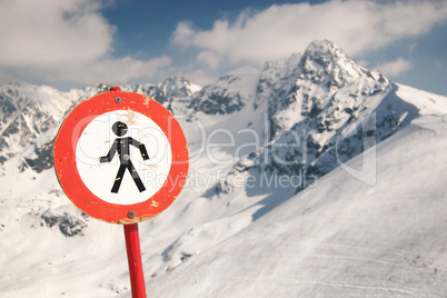 Warning sign in snowy mountains