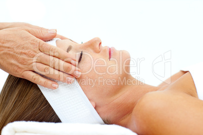 Asleep woman relaxing with head massage