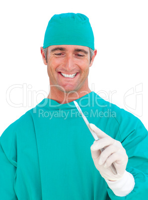 Smiling surgeon holding a scalpel
