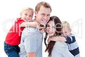 Portrait of joyful family enjoying piggyback ride against a whit