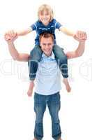 Smiling father giving his son piggyback ride