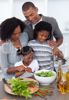 Affectionate family preparing salad together