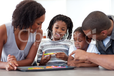 Happy family eating handmade cookies