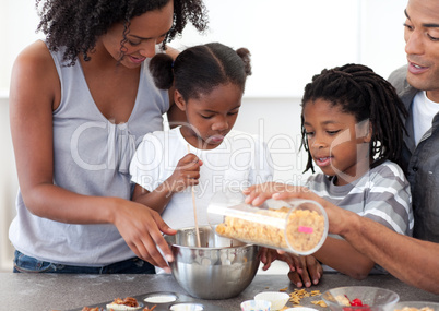 Ethnic family making biscuits together