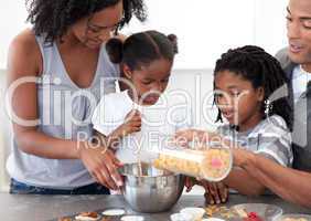 Ethnic family making biscuits together