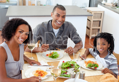 Ethnic couple dining with their son