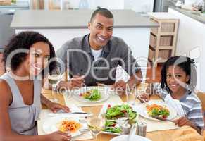 Ethnic couple dining with their son