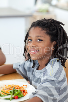 Portrait of ethnic little boy dining